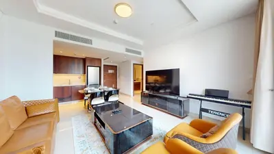 a living room with a couch and a table at Boulevard Point - One Bed with Burj Khalifa View in Dubai