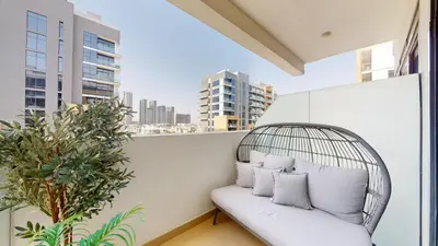 a rattan bench on a balcony with a view of a city at Azizi Riviera 18 - Peaceful Studio in Meydan in Dubai