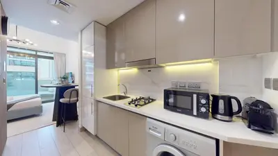 a kitchen with a sink and a microwave at Azizi Riviera 18 - Peaceful Studio in Meydan in Dubai