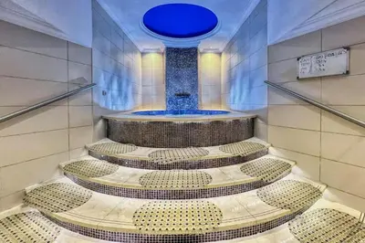 a bathroom with a shower with a blue fountain at Cozy and Spacious 2Bedroom with Marina Bay view in Dubai