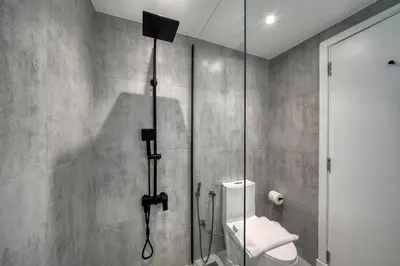 a bathroom with a shower with a toilet in it at Cozy and Spacious 2Bedroom with Marina Bay view in Dubai