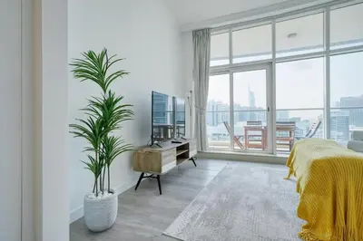 a bedroom with a bed and a large window at Cozy and Spacious 2Bedroom with Marina Bay view in Dubai