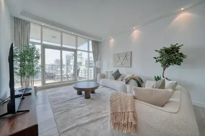 a living room with a couch and a table at Cozy and Spacious 2Bedroom with Marina Bay view in Dubai