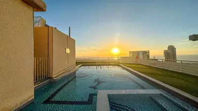 a pool on the balcony of a building with the sunset at Luxury 3BHK w Floating Bed in Dubai Marina Man 2805 in Dubai