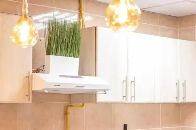 a kitchen with a stove and some cabinets and lights at Luxury 2BHK in Dubai Marina By dPie MP 1514 in Dubai