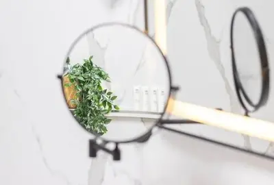 a magnifying glass with a plant on a shelf at Luxury 2BHK in Dubai Marina By dPie MP 1514 in Dubai