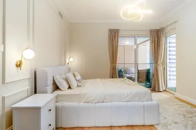 a bedroom with a white bed and a white couch at Luxury 2BHK in Dubai Marina w Views Sulafa 1101 in Dubai
