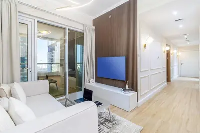 a living room with a white couch and a tv at Luxury 2BHK in Dubai Marina w Views Sulafa 1101 in Dubai