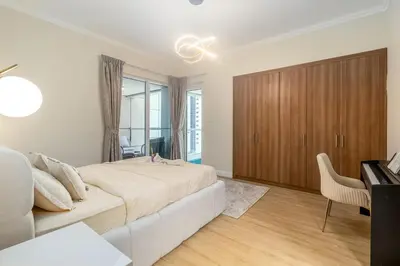 a white bedroom with a large bed and a desk at Luxury 2BHK in Dubai Marina w Views Sulafa 1101 in Dubai