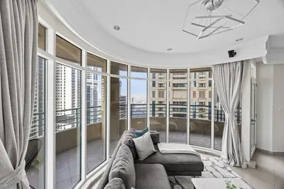 a living room with a couch and large windows at Elegant 2BR - Stunning Sea Views & Prime Location in Dubai