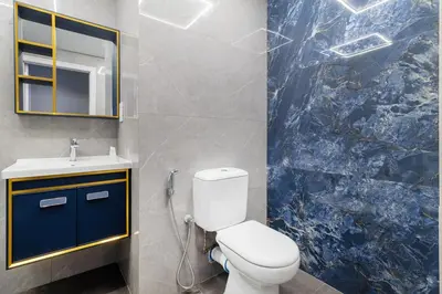 a bathroom with a toilet and a sink and a mirror at Lux 4BHK in JBR 5 Mins Walk to Beach Sadaf 2 404 in Dubai