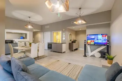 a living room with a blue couch and a tv at Lux 4BHK in JBR 5 Mins Walk to Beach Sadaf 2 404 in Dubai