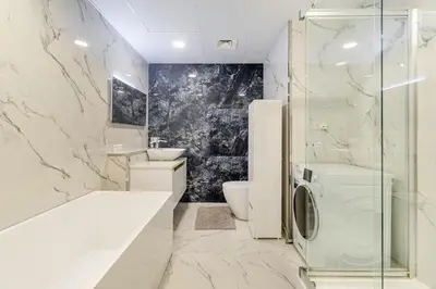 a bathroom with a sink and a washing machine at Lux 4BHK in JBR 5 Mins Walk to Beach Sadaf 2 404 in Dubai