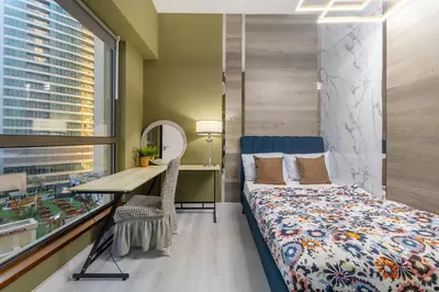 a bedroom with a bed and a desk with a mirror at Lux 4BHK in JBR 5 Mins Walk to Beach Sadaf 2 404 in Dubai