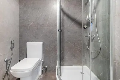 a bathroom with a toilet and a glass shower at Lux 4BHK in JBR 5 Mins Walk to Beach Sadaf 2 404 in Dubai