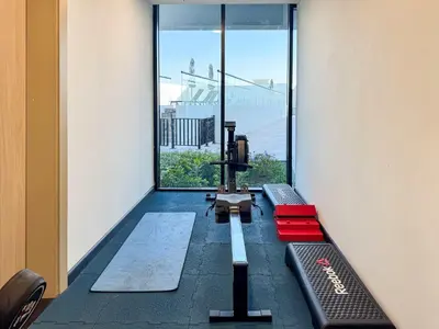 a room with a view of a gym with a camera at PVH - Modern 1BR Near Metro - Alexis Tower in Dubai