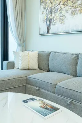 a living room with a couch and a table at PVH - Modern 1BR Near Metro - Alexis Tower in Dubai