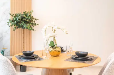 a wooden table with plates and bowls on it at PVH - Canal View 1BR - Burj Royale in Dubai