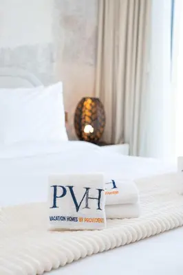a hotel room with a bed with towels on it at PVH - Canal View 1BR - Burj Royale in Dubai