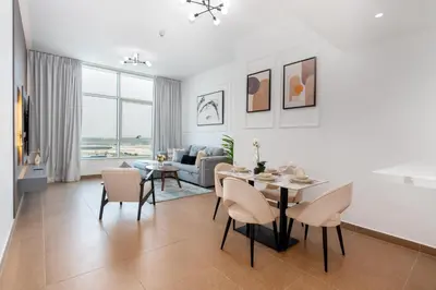 a white living room with a table and chairs at White Sage Newly Renovated 1BR Business Bay Hamilton Residency in Dubai
