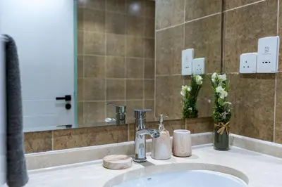 a bathroom with a sink and a mirror at White Sage Newly Renovated 1BR Business Bay Hamilton Residency in Dubai