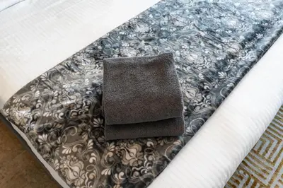 a brown napkin sitting on top of a bed at White Sage Newly Renovated 1BR Business Bay Hamilton Residency in Dubai