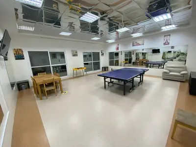 a room with a ping pong table and chairs at Studio with homely cozy and positive vibes in Sabkhah