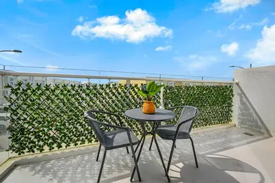 a patio with a table and chairs on a balcony at Modern 1 Bedroom Apartment in Damac Hills 2 in Dubai