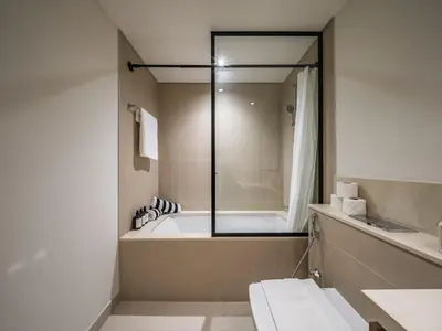 a bathroom with a bath tub and a sink at The Norway Condo - 2BR Burj Khalifa View in Dubai
