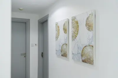a row of three paintings hanging on a wall at Dubai Marina - 2BHK Luxurious Apartment in Dubai