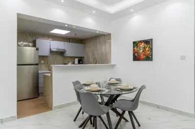 a kitchen and dining room with a table and chairs at Dubai Marina - 2BHK Luxurious Apartment in Dubai