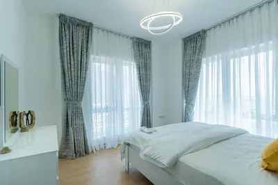 a bedroom with a bed and a large window at Dubai Marina - 2BHK Luxurious Apartment in Dubai