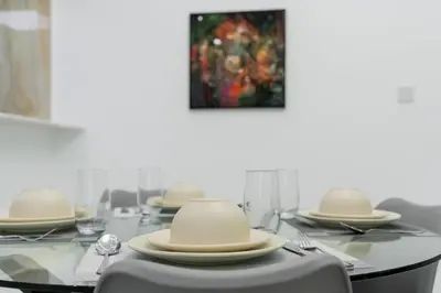 a table with a hat and plates on it at Dubai Marina - 2BHK Luxurious Apartment in Dubai