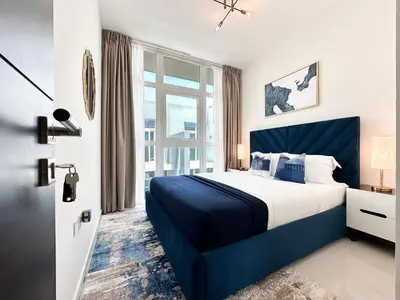 a bedroom with a blue bed and a window at Stylish 3BR Retreat Bright Interiors Townhouse Comfort in Dubai