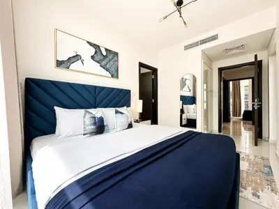 a bedroom with a blue bed with a blue headboard at Stylish 3BR Retreat Bright Interiors Townhouse Comfort in Dubai
