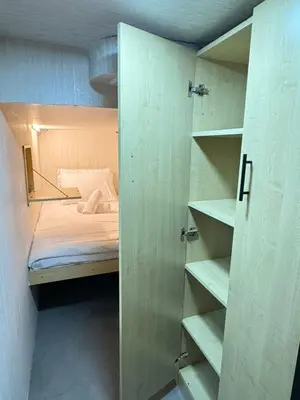 a small room with a bed and a closet at Luxury Private Capsule Room near Business Bay Downtown in Dubai