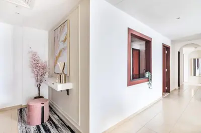 a hallway with white walls and a pink trash can at MiamiDXB Full Sea View -2Bd apartment in Dubai