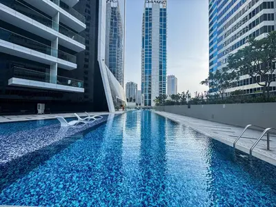 a swimming pool in a city with tall buildings at Spacious Studio Private Balcony Sea View in Dubai