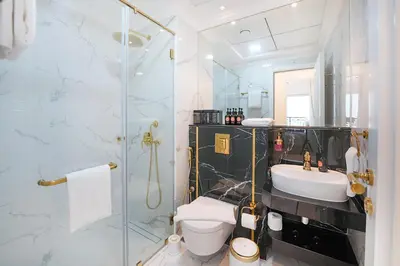 a bathroom with a shower and a toilet and a sink at EasyGo- Luxury Living with Resort Facilities and Amenities in Dubai