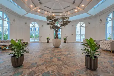 a large room with two potted trees in the middle at EasyGo- Luxury Living with Resort Facilities and Amenities in Dubai