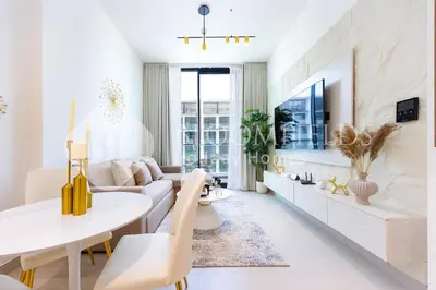 a living room with a couch and a table at Bloomfields Cozy 1Br Binghatti House in Dubai