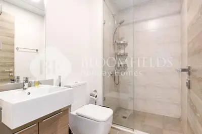 a bathroom with a shower and a toilet and a sink at Bloomfields Spacious 1br Bloom Tower in Dubai