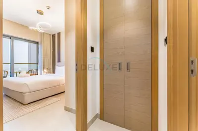 a room with a closet with a bed and a bedroom at High Floor, Few Steps From Dubai Canal and Waterfront Promenade, Sobha Hartland Waves, Sobha Hartland by Deluxe Holiday Homes in Dubai