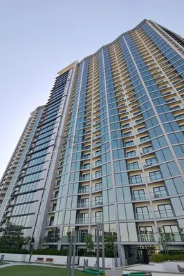 a tall building with a lot of windows at High Floor, Few Steps From Dubai Canal and Waterfront Promenade, Sobha Hartland Waves, Sobha Hartland by Deluxe Holiday Homes in Dubai