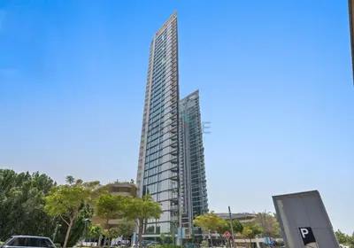 a tall building in a city with a blue sky at High Floor, Few Steps From Dubai Canal and Waterfront Promenade, Sobha Hartland Waves, Sobha Hartland by Deluxe Holiday Homes in Dubai