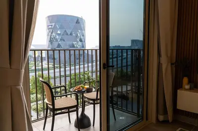 a room with a balcony with a table and chairs at New Luxury 1 Bed - Opposite Dubai Hills Mall in Dubai
