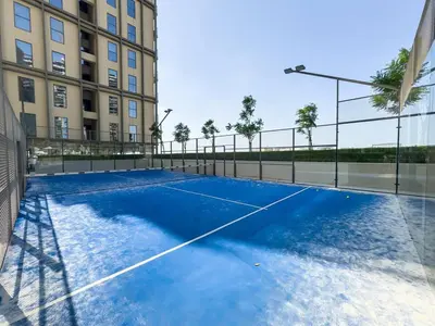 a tennis court in front of a building at New Luxury 1 Bed - Opposite Dubai Hills Mall in Dubai
