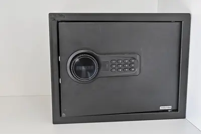 a black safe with the door open on a counter at Golden Stays - 5 Mins From Mall I Downtown Dream 1Br Apt in Dubai