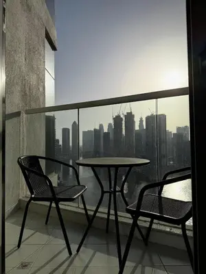 a table and two chairs on a balcony with a view at Apartment In Downtown Dubai in Dubai