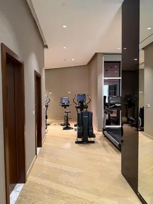 a fitness room with treadmills and elliptical machines at Apartment In Downtown Dubai in Dubai